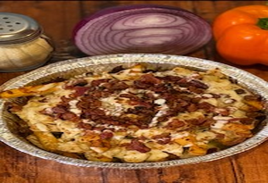 Genos Giant Slice pizza in foil pan, topped with bacon and cheese, surrounded by onion and pepper.