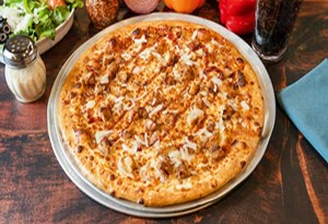image002 Genos Giant Slice pizza on metal tray, golden crust, cheese and sausage toppings, served on wooden table with condiments nearby