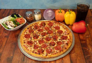Genos Giant Slice pizza with pepperoni, served on metal tray with vegetables and condiments on wooden table